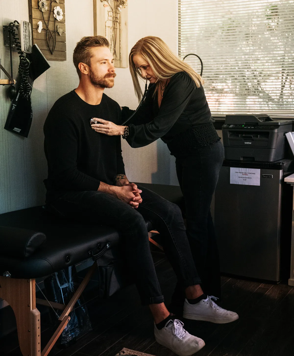 A Redpoint clinician checking in with a client during a medical visit.
